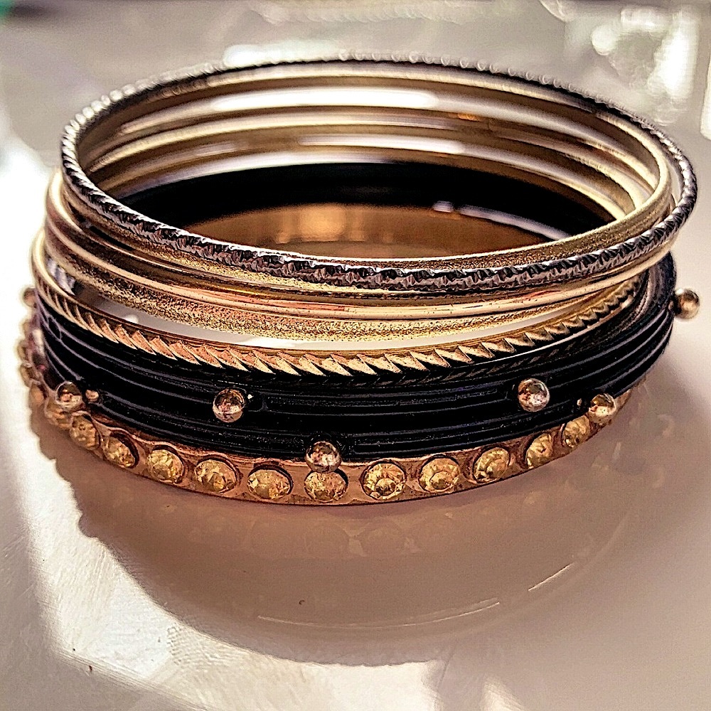 black and gold colored bangle bracelets stack